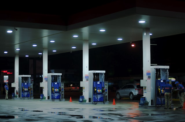 Retail fuel station forecourt at night